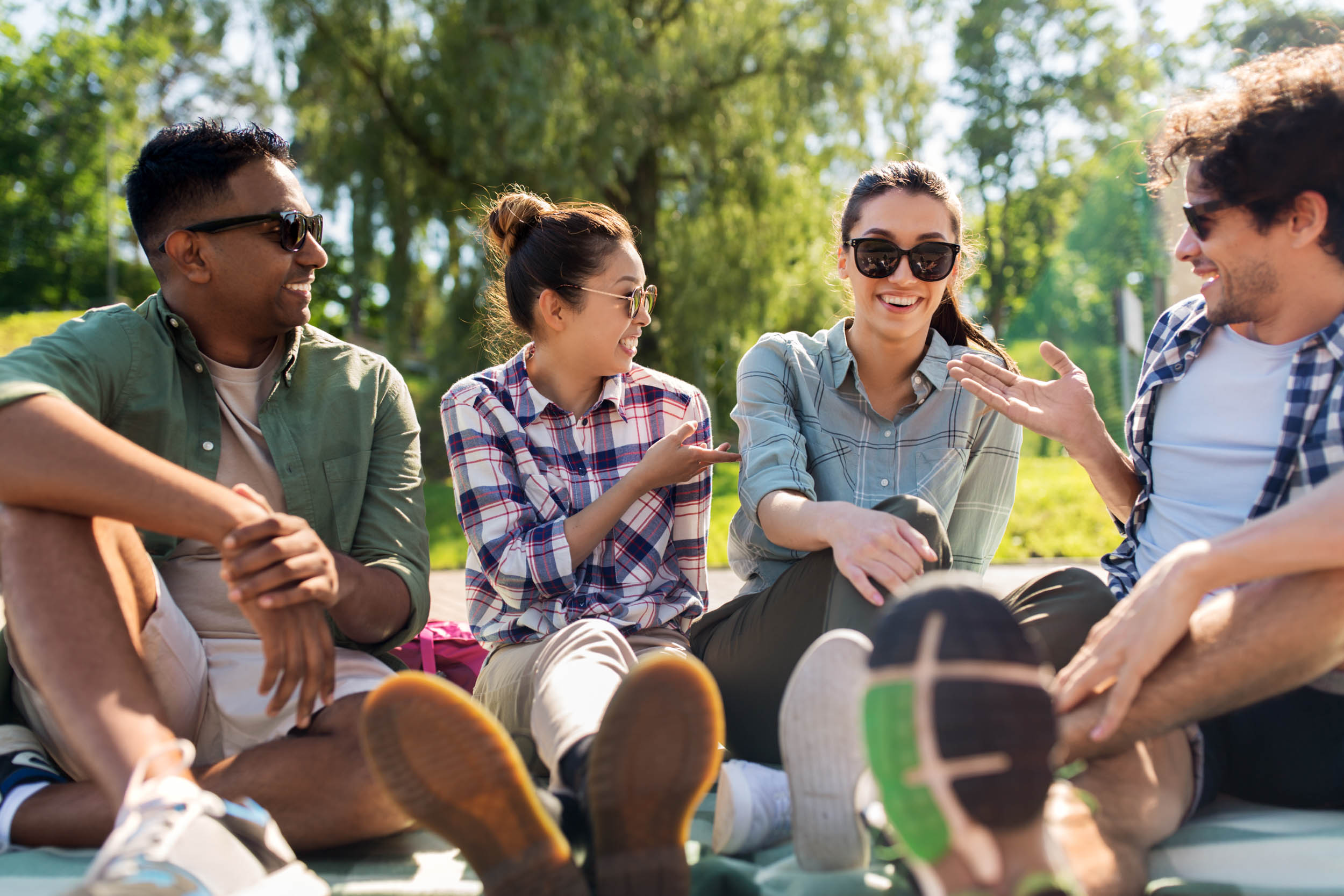 Friends Hanging Out and Talking Outdoors in Summer